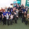 Supporters, students and staff from the Deaf Academy are pictured using the BSL sign for applause