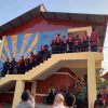 Children at the new school with their bags