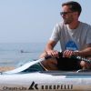 Picture shows paddleboatrder with his board and oars