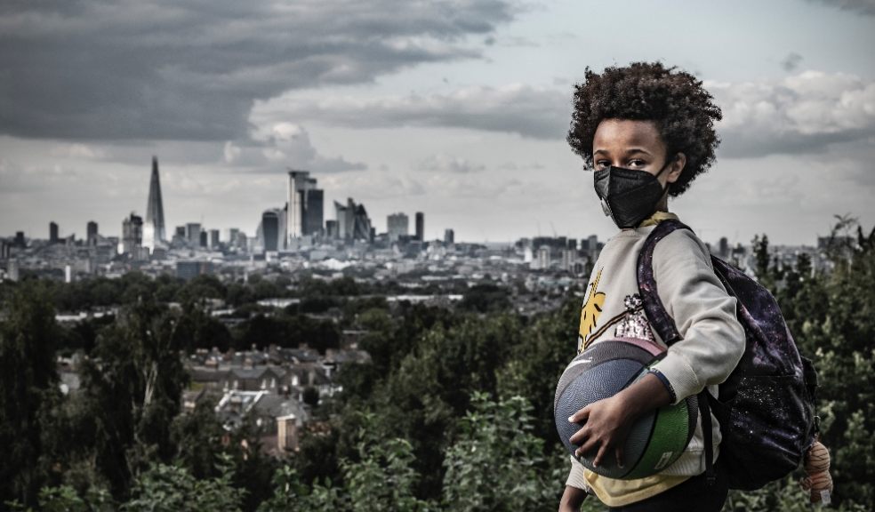 Boy in mask: Afrika, 8, holds a ball and wears a mask to protect against air pollution in Dawson Heights, south east London. Image credit: © Britta Jaschinski / WWF-UK