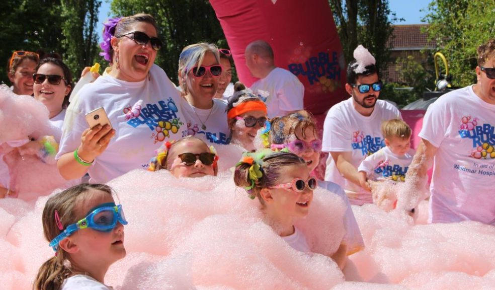 A family enjoying a bubble station at a family fun run Bubble Rush 