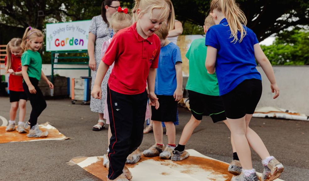 Children doing group art project with their feet