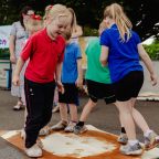 Children doing group art project with their feet