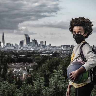 Boy in mask: Afrika, 8, holds a ball and wears a mask to protect against air pollution in Dawson Heights, south east London. Image credit: © Britta Jaschinski / WWF-UK