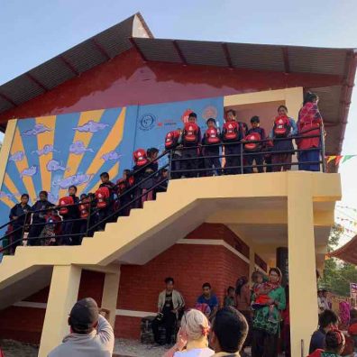 Children at the new school with their bags