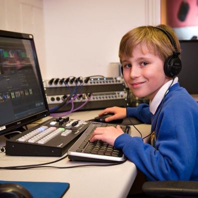 Year 4 BCPS student using desktop computer and headphones