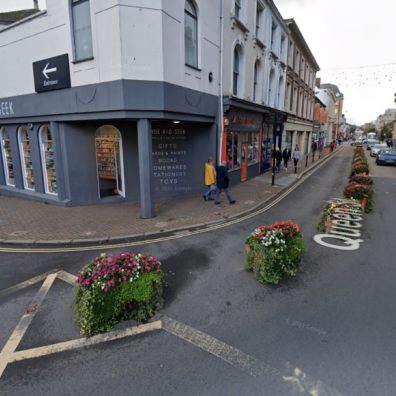 Road showing planters, shops in city