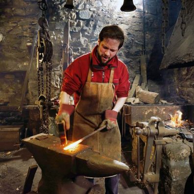 Shaping metal on the anvil. Photo: John Millar, National Trust Images 