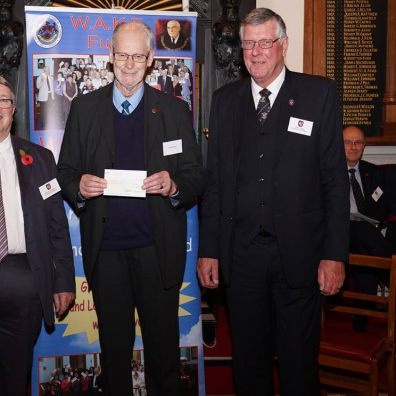 Peter Holman receiving the cheque from Ian Kingsbury accompanied by W. Bro. Clive Eden from St. Michaels Lodge in Dawlish.